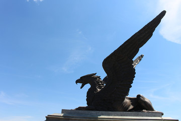 Statue of Griffin or Griffon against the sky. A legendary creature with the body of a lion, the...