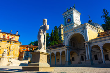 Fototapeta na wymiar Church and clock tower on Piazza liberta, Udine, Italy