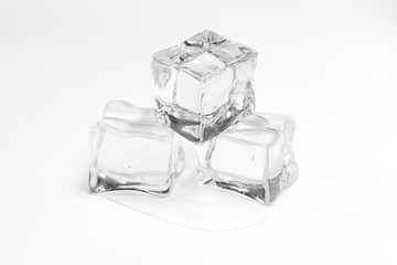 Wet ice cubes isolated on white background.Heap of melting ice on the plate.
