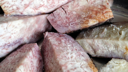 Close up of steamed purple yam slices.