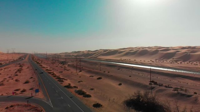 Slow drone rise over lonely road next to Arizona desert and Waterway