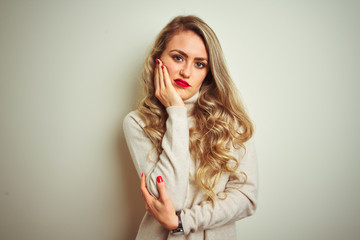 Beautiful woman wearing winter turtleneck sweater over isolated white background thinking looking tired and bored with depression problems with crossed arms.