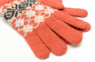 Red woolen gloves on white background. Womanly clothes