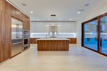 Interior design of a modern kitchen in the newly built house  with stainless steel appliances.