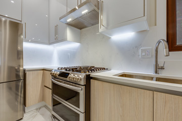 Interior design of a modern kitchen in the newly built house  with stainless steel appliances.