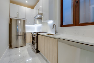 Interior design of a modern kitchen in the newly built house  with stainless steel appliances.