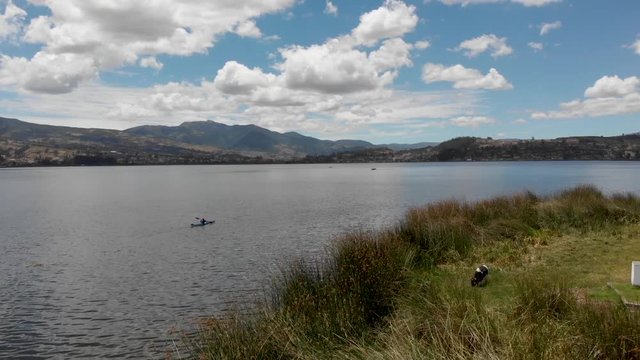 Dron flying backwards revealing two Kayacks on the Lake San Pablo near the shore