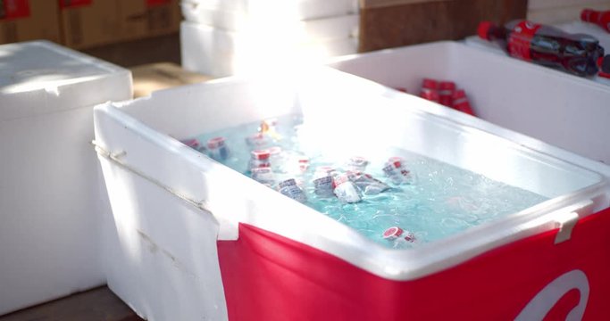 Ice cold drinks sitting in a ice cold container on a hot summer day at a festival, matsuri, in Kyoto, Japan soft lighting slow motion 4K