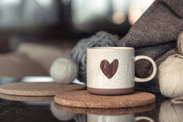 Cozy Autumn background with a beautiful Cup with a heart.