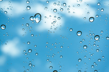 Rain on the window, natural skin of the rain The natural form of rainwater on a sky background.