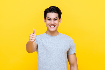 Smiling Asian man giving thumbs up