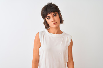 Young beautiful woman wearing casual t-shirt standing over isolated white background with serious expression on face. Simple and natural looking at the camera.