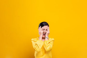 Angry woman screaming isolated over yellow background