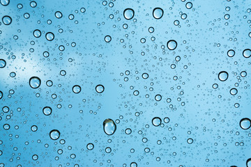 Rain on the window, natural skin of the rain The natural form of rainwater on a sky background.
