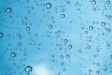 Rain on the window, natural skin of the rain The natural form of rainwater on a sky background.