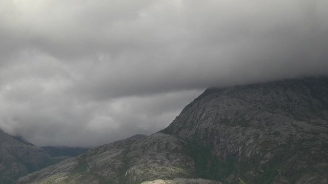 Mountain on a rany day with moving fog.