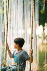 Young kid swing in the park.