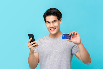 Asian man paying his online shopping through credit card