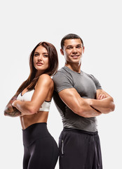 Portrait of two young fit sporty people with crossed hands