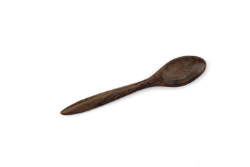 Wooden spoon placed on a white background.