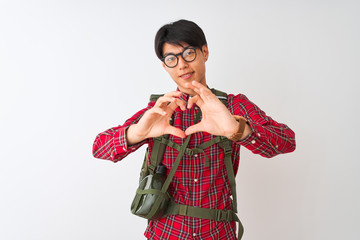 Chinese hiker man wearing backpack canteen glasses over isolated white background smiling in love doing heart symbol shape with hands. Romantic concept.