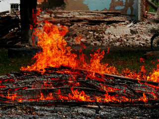 Fire at a construction site. Flames of fire against the backdrop of ruins.
