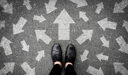 Selfie of shoes and arrows on road or pathway. Top view.  - obrazy, fototapety, plakaty