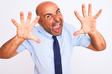 Middle age businessman wearing tie standing over isolated white background showing and pointing up with fingers number ten while smiling confident and happy.