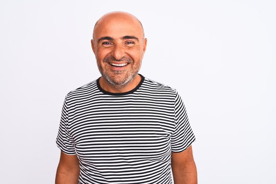 Middle age handsome man wearing striped navy t-shirt over isolated white background with a happy and cool smile on face. Lucky person.