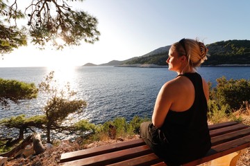 attractive women enjoying the sea scape with warm evening sun