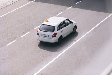 Fototapeta na wymiar Top view white car moving on asphalt road