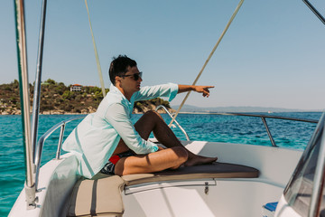 Naklejka premium man relaxing on yacht in the sea. man on board of boat in Greece