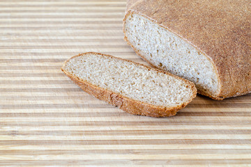 Whole grain round bread on a wooden surface
