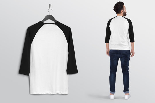 Hanging white and black  plain raglan t shirt on wall along with male model in blue denim jeans pant. Isolated background