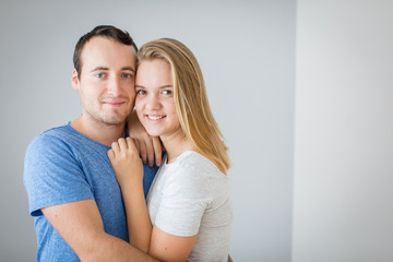 Brother and sister posing for a photo together. Hugging and smiling, feeling caring and loved.