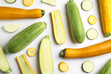 Fresh ripe zucchinis on white background, top view