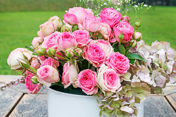 Beautiful floral arrangement with pink roses, hortensia and gypsophila paniculata