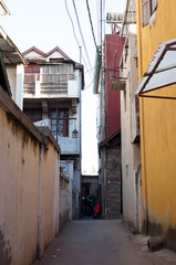 Fototapeta na wymiar Grungy narrow dangerous looking back alley