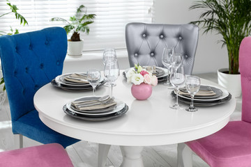 Elegant dining room interior with stylish chairs and table