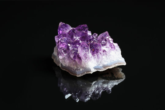 Beautiful purple amethyst gemstone on black background