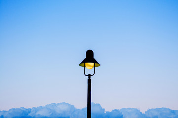 Vintage retro light pole with blue sky background