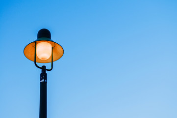 Vintage retro light pole with blue sky background