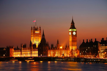 Fototapeta na wymiar Night view of Westminster Palace over dramatic sunset sky