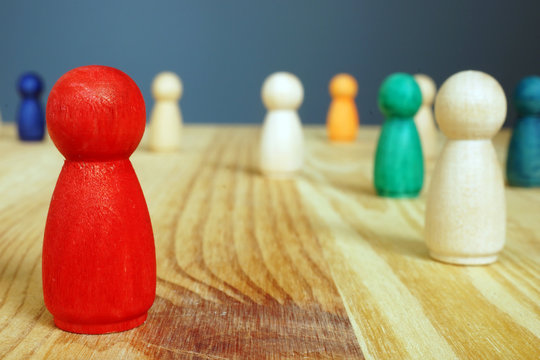 Diversity and inclusion concept. Red figure and oter wooden figures.