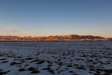 Field at Sunset with Snow and Mountains