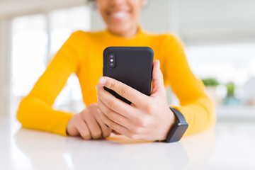 Close up of young african woman using smartphone