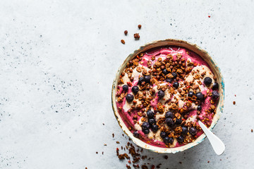 Berry smoothie bowl with peanut butter and granola. Healthy vegan food concept.