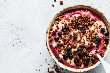 Berry smoothie bowl with peanut butter and granola. Healthy vegan food concept.