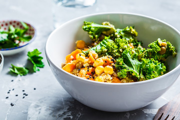 Vegan stew with chickpeas, sweet potato and kale in white bowl. - obrazy, fototapety, plakaty