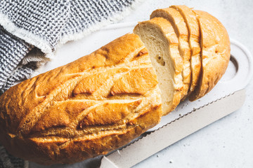 Sliced wheat bread on the white board.